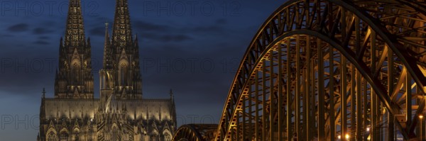 Evening atmosphere, Cologne Cathedral illuminated with LED lamps and the Hohenzollern Bridge,