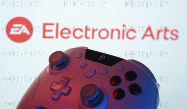 Dhaka, Bangladesh- 24 Mar 2025: A close-up of a gamepad with the Electronic Arts seen on screen in