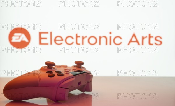 Dhaka, Bangladesh- 20 Mar 2025: A close-up of a white gamepad with the Electronic Arts seen on