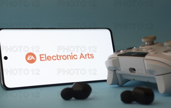 Dhaka, Bangladesh- 23 Mar 2025: A smartphone with a Electronic Arts icon next to a controller and