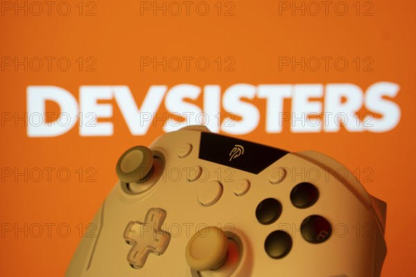 Dhaka, Bangladesh- 20 Mar 2025: A close-up of a gamepad with the Devsisters seen on screen in the