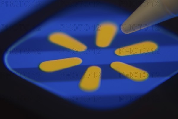 Dhaka, Bangladesh- 06 Dec 2025: Close-up of the Walmart app on a screen with a stylus pointing at