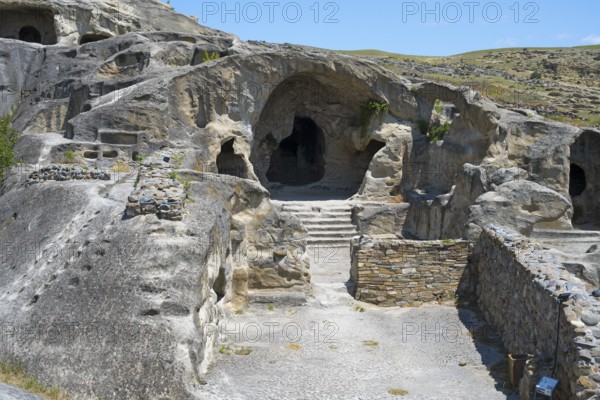 Ancient rock construction with several entrances and a natural setting, Uplistsikhe cave town,
