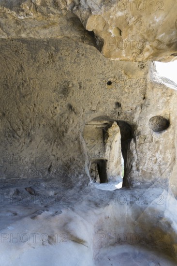 Rough stone cave walls with light and shadow effects inside, cave town Uplistsikhe, Inner Kartli