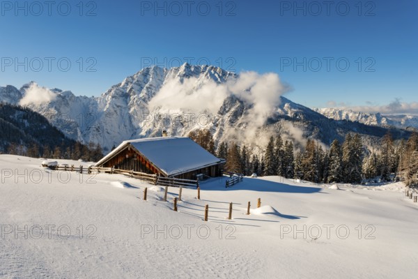 Deep snow-covered Priesbergalm, Watzmann with clouds behind, Berchtesgaden Alps, Berchtesgaden