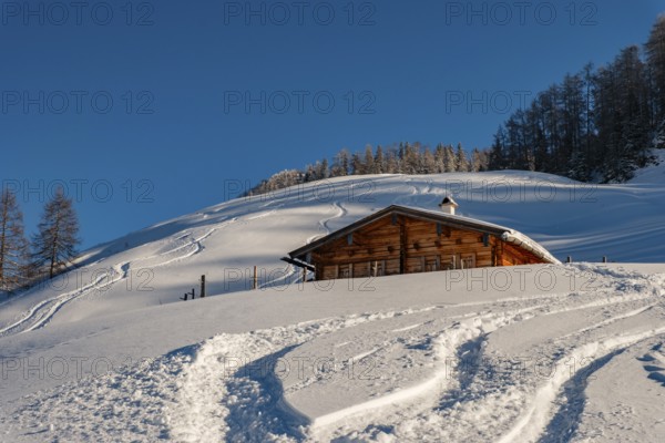 Upper Priesbergalm surrounded by deep snow with ski tracks, Berchtesgaden Alps, Berchtesgaden