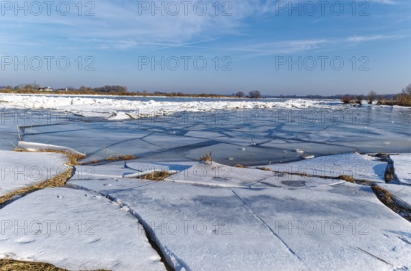 Ice on the banks of the Elbe and remnants of snow in the foothills of the Elbe on a clear winter