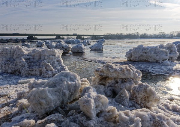 Ice skating on the Elbe with small icebergs on the water and on the banks of the Elbe Island near