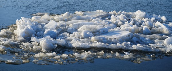 Accumulation of ice chunks on calm water surface on a cold winter day, ice floes, Elbe-Havel Canal,