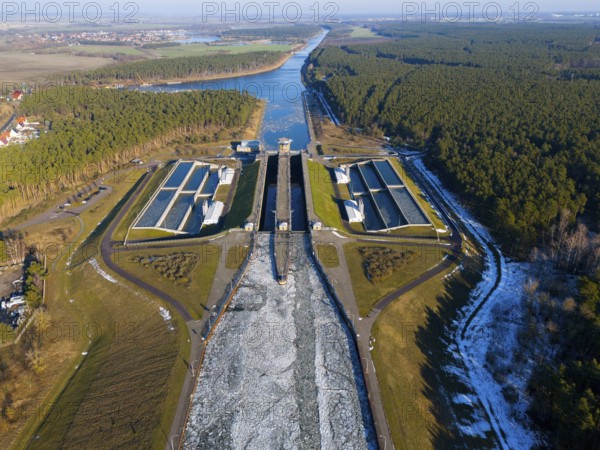 Aerial view of a lock surrounded by forests, surrounded by ice-covered waterways, aerial view,