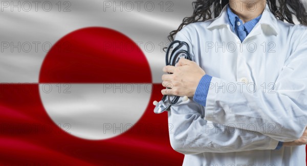 Healthcare professional with Greenland flag background. Professional doctor holding stethoscope on