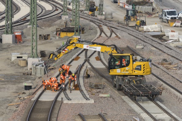 Workers and excavators renovating railroad tracks on a municipal construction site, Untertürkheim