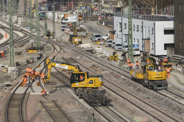 Several workers and excavators on a railway construction site in an urban area, Untertürkheim