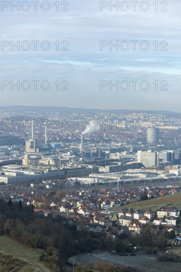 Panoramic view of a hilly urban landscape with industrial areas and residential buildings, view of