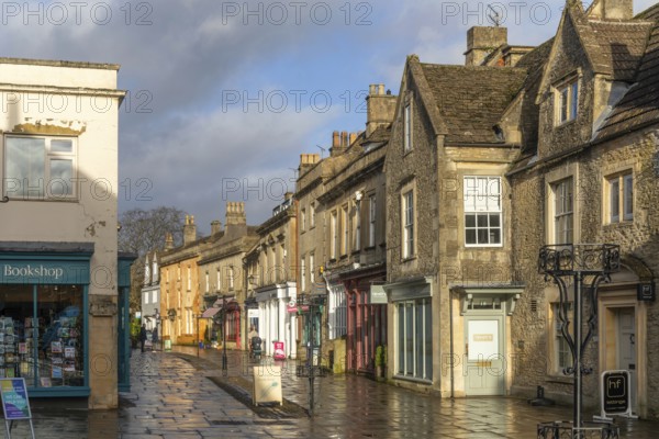 Wet pavements after rain in pedestrianised High Street are of town centre of Corsham Wiltshire,