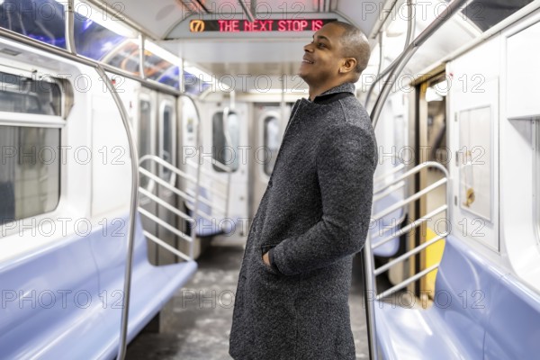 Young man riding new york city subway, traveling to work and navigating urban transport,