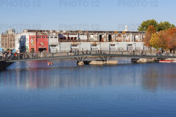 Pedestrian walkway bridge over Bonsecours basin leading to Parc du Bassin Bonsecours in autumn, Old