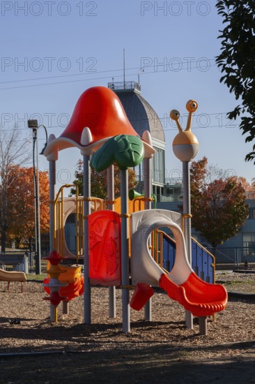 Colorful kids plastic playground equipment with slides and climbing bars in Parc du Bassin
