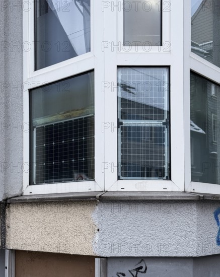Window front, bay window with solar panels used, sustainable and unusual energy generation in
