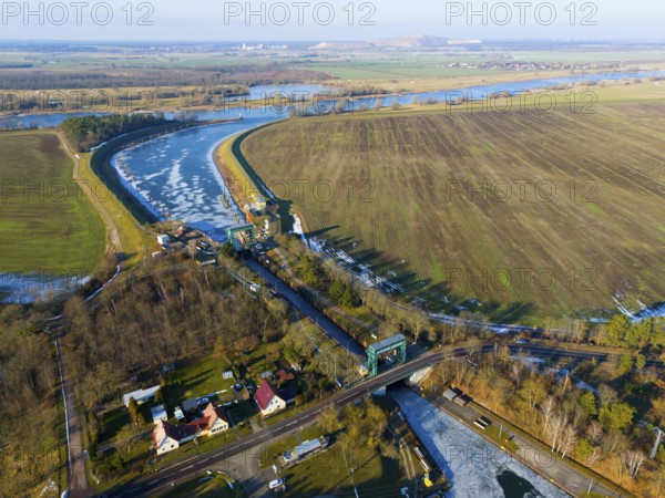 Lock surrounded by fields and a river curve, with an adjacent village, aerial view, Niegripp lock,