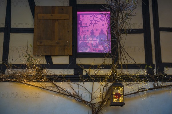 Christmassy decorated half-timbered house, Christmas market, Eguisheim, Haut-Rhin department, Grand