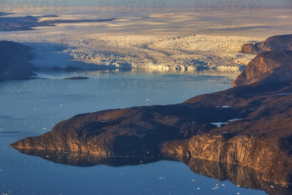 Aerial view of coast and Greenland ice sheet, Arctic landscape, frozen wilderness, glaciers and