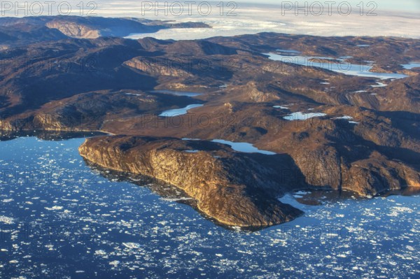 Aerial view of the coast and Greenland ice sheet, Arctic landscape, frozen wilderness, glaciers and