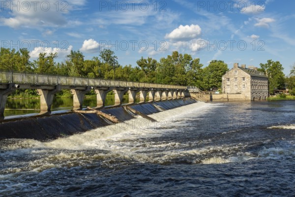 Moulin Neuf water flow control dam and walkway over Des Mille-Iles river plus New Mill on Ile des