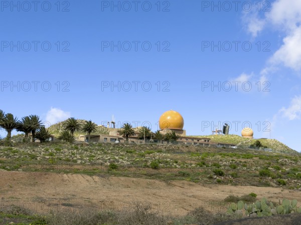 Radar domes on the Peñas del Chache against a blue sky, Caleta de Famara, Lanzarote, Canary