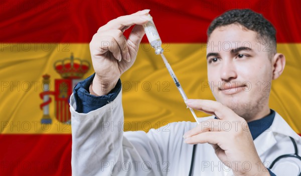 Doctor holding syringe on Spain flag background. Medical professional holding syringe with Spanish