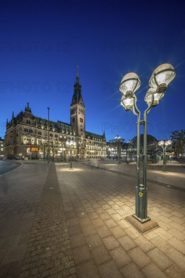 Hamburg City Hall with illuminated blue hour façade and street lamp in the foreground, Hamburg,