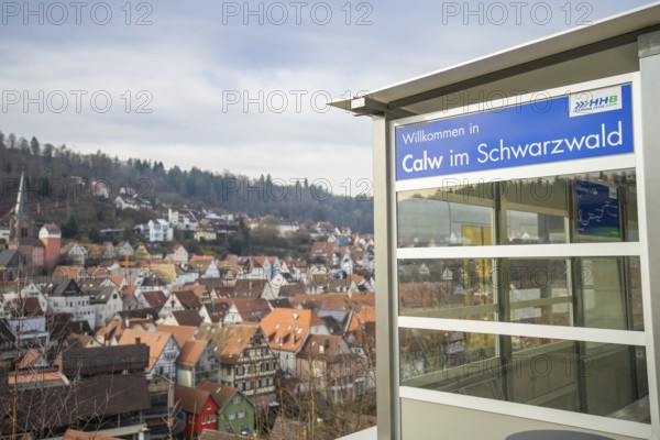 A Calw sign with a picturesque view of a village in the Black Forest, taking off the Hermann