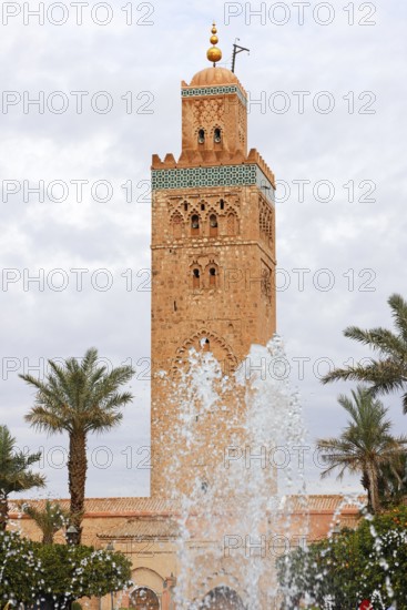 Minaret of the Koutoubia Mosque with water fountain from a fountain, landmark of Marrakech,