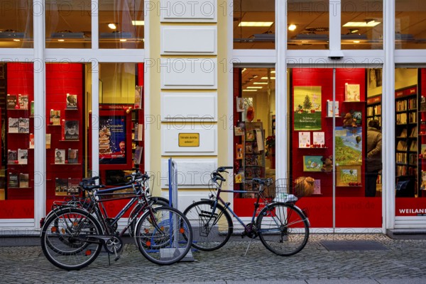Bicycles parked in front of the Weiland bookstore at the fish market in the Hanseatic City of