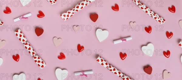 Cute Valentine's Day banner with pink, white and red hearts and small gift bags on a pastel pink