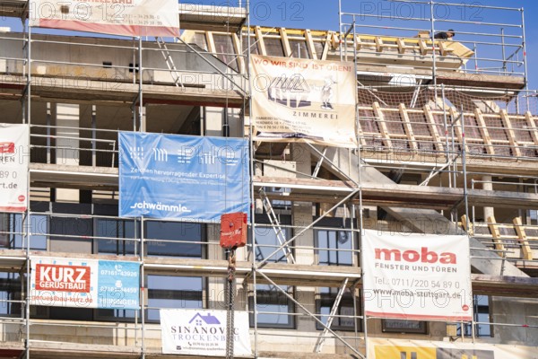 A scaffolding with various corporate advertising banners on a building, carpentry, new building,
