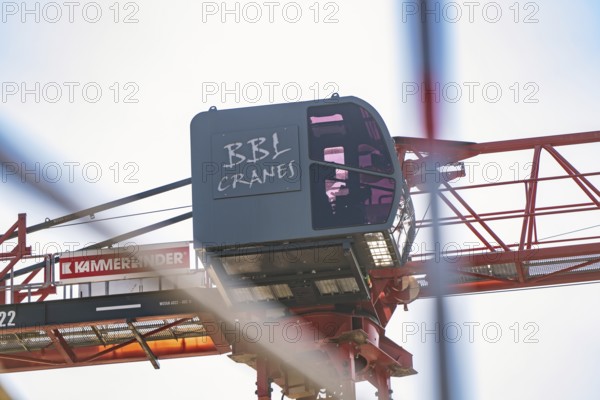 Side view of a construction crane with focus on the crane operator cabin and structures, carpentry,