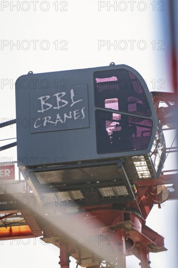 Close-up of a crane operator cabin with lettering in the construction zone, carpentry, new