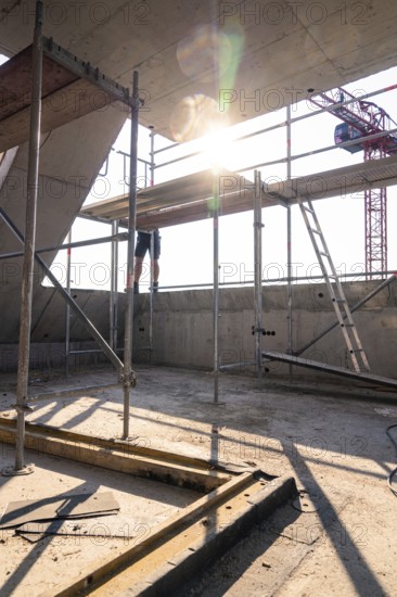 Construction site scene with scaffolding and sunlight, construction worker working on construction,