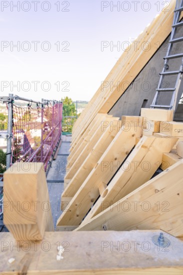 Timber structure of a roof with a view of scaffolding in daylight, carpentry, new building,