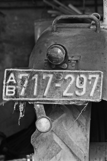 Old tractor license plate from the 1950s, on a former Franconian farm, black and white, Bavaria,