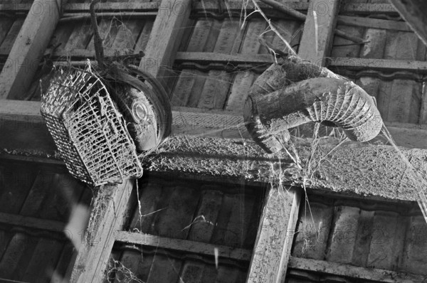 Dusty shopping basket and chimney pipes on the grain and hayloft, on a former Franconian farm,