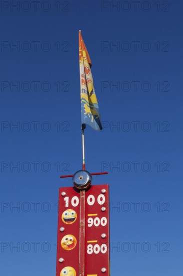 Close-up of High Striker game of strength with numbered score levels at Fun Show traveling