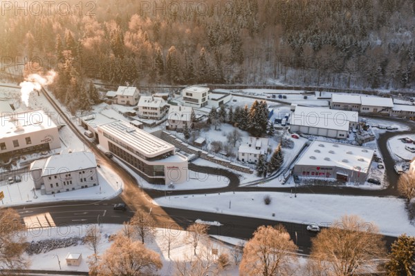 Snowy buildings and roads in an industrial and residential area during winter, Nagold, Calw