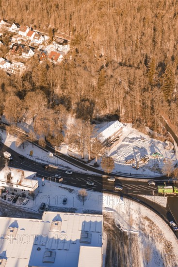 Snowy road junction on the edge of a forest with adjacent buildings, Nagold, Calw district, Black