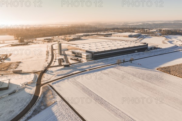 Large industrial site in snow-covered landscape under bright skies, Nagold, Calw district, Black