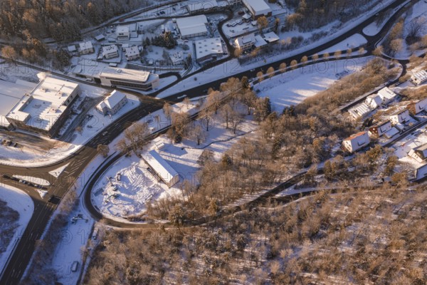 Bird's eye view of a snowy winter landscape with roads, buildings and forests, Nagold, Calw