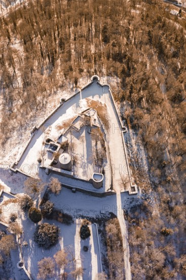 Aerial view of a snowy castle with a triangular layout surrounded by trees, Nagold, Calw district,