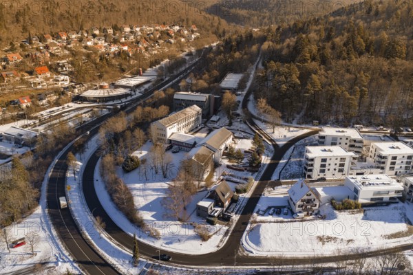 Snowy bird's-eye view of city with buildings and curved road, Nagold, Calw district, Black Forest,