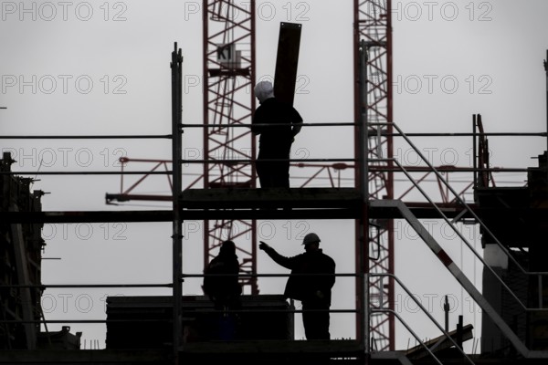 Construction site, scaffolding work on a large construction project, apartments and commercial